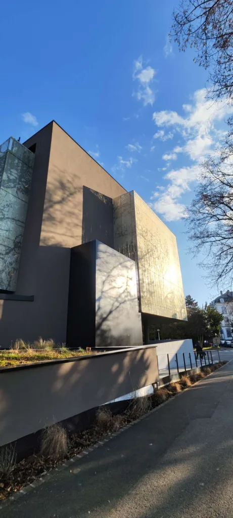 a building with a fence and trees